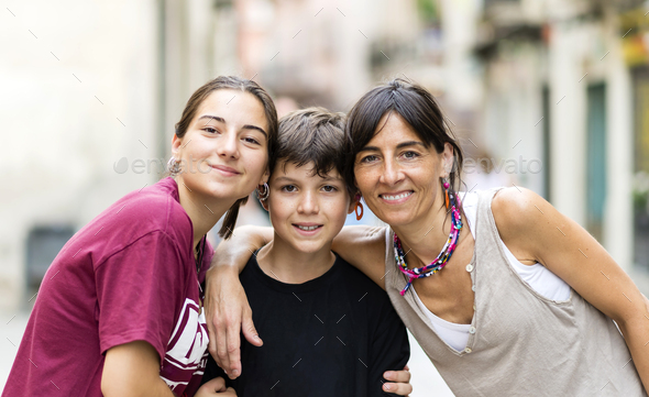 Affectionate People Mom Teen Daughter And Little Son Embracing Outside